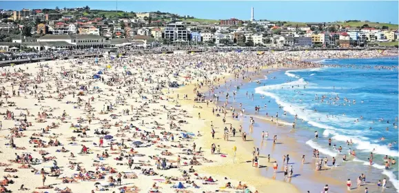  ??  ?? People cooling off at Bondi Beach in Sydney.