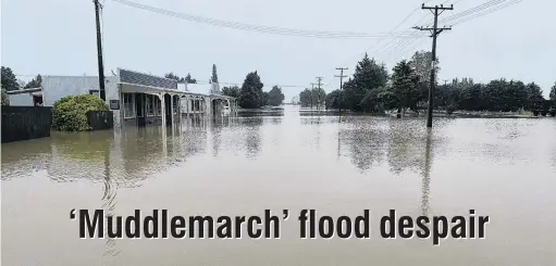  ?? PHOTO: RICHARD EMERSON ?? Big challenge . . . Snow Ave, Middlemarc­h, with the Tap & Dough Bistro at left, looked more like a river, during flooding on Saturday evening.