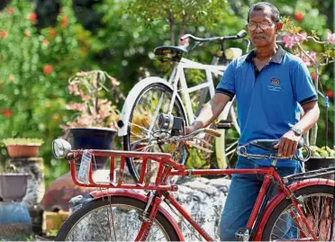  ??  ?? Special delivery: Bahri showing one of his vintage postman bicycles, which originally cost him RM15 but is now worth thousands of ringgit. — Bernama