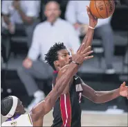  ?? MARK J. TERRILL— THE ASSOCIATED PRESS ?? Miami Heat’s Jimmy Butler shoots the ball during the Heat’s win in Game 3of the NBA Finals on Sunday.