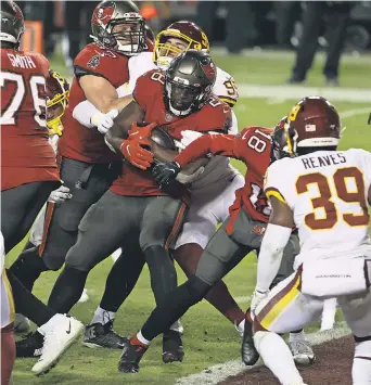  ?? GEOFF BURKE/ USA TODAY SPORTS ?? Buccaneers running back Leonard Fournette scores a TD against Washington in the fourth quarter Saturday at FedExField. He finished with 93 yards rushing.