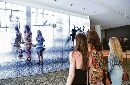  ?? Daniel Ortiz ?? Visitors interact with William Forsythe’s “City of Abstracts” at the Museum of Fine Arts, Houston.