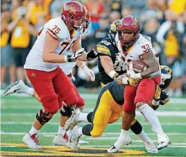  ?? [AP PHOTO] ?? Iowa State running back David Montgomery, right, is tackled by Iowa linebacker Djimon Colbert during the second half Saturday in Iowa City, Iowa.