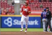  ?? AARON DOSTER — THE ASSOCIATED PRESS ?? The Reds’ Kyle Farmer runs the bases after hitting a tworun home run during the second inning against the Cubs in Cincinnati on Thursday.