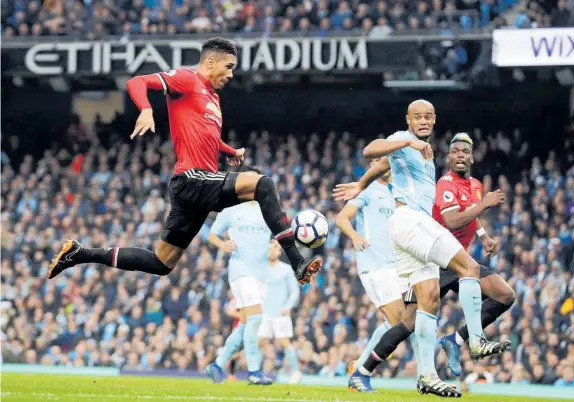  ?? Picture / AP ?? Chris Smalling (left) scores Manchester United winner in yesterday’s derby clash at the Etihad Stadium.