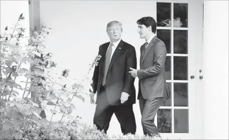  ?? Jim Watson AFP/Getty Images ?? AT ONE POINT during the meeting between President Trump, left, and Canadian Prime Minister Justin Trudeau, Trump said he could see the U.S. and Canada doing a bilateral deal to replace NAFTA. Trudeau, when asked about the idea, noted that talks were...