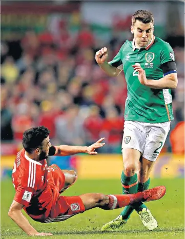  ??  ?? Red-card offence: Neil Taylor goes in for the tackle which left Seamus Coleman in agony (inset) and with his career under threat