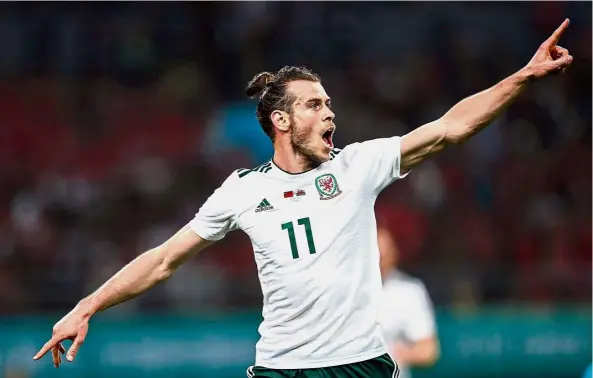  ?? — Reuters ?? Solid strike: Wales’ Gareth Bale celebratin­g after scoring against China in the China Cup semi-finals at the Guangxi Sports Centre in Nanning on Thursday.