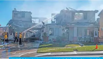  ??  ?? AGUA DULCE: Firefighte­rs hose down a burning house during the Tick Fire in Agua Dulce near Santa Clarita, California. — AFP