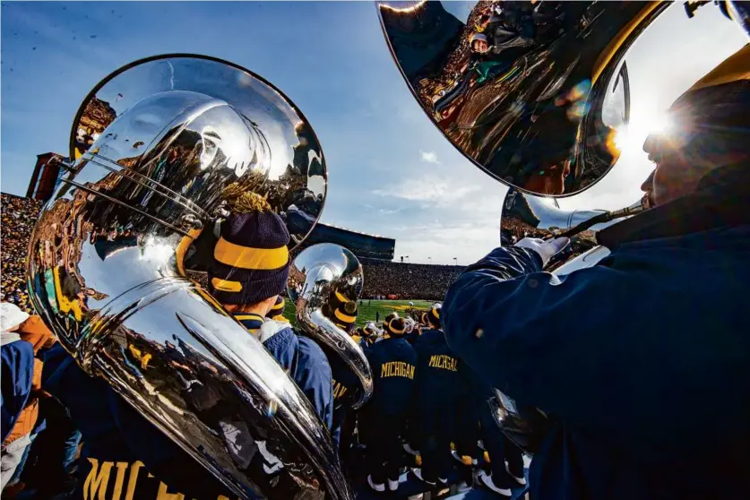  ?? ?? The Michigan Marching Band is a fixture in “The Big House.” The stadium’s official capacity is 107,601, but 10 years ago it hosted a record 115,109 for a game against Notre Dame.