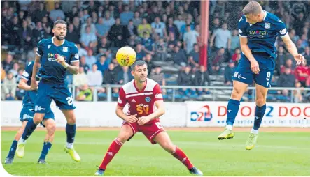  ??  ?? Andy Nelson rises to head home Dundee’s winner against Ayr United