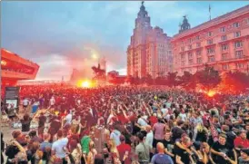  ??  ?? Liverpool FC fans ignite flares outside the Liver Building in Liverpool as they celebrate the team’s English Premier League title on Friday.
AP