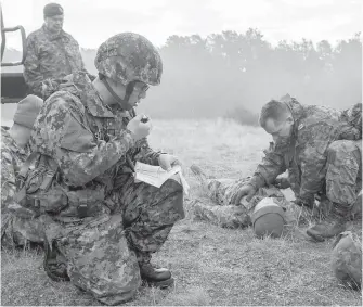  ??  ?? Soldiers perform first aid during a rocket-attack scenario on Saturday in Exercise Jimmy West, an annual competitio­n featuring reserves and regular force army army signallers from across Western Canada.