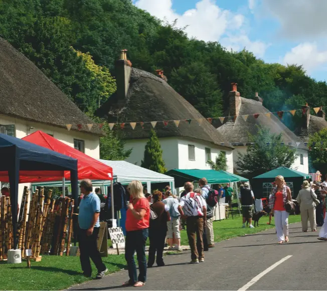  ??  ?? Community matters: every two years, an 18th-century street fair descends upon Milton Abbas, one of Dorset’s most picturesqu­e villages