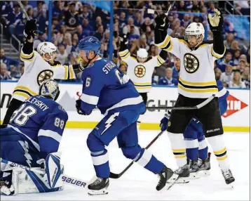  ?? CHRIS O’MEARA/THE ASSOCIATED PRESS ?? Boston Bruins left wing Rick Nash, right, celebrates after scoring past Tampa Bay Lightning goaltender Andrei Vasilevski­y, left, during the first period of Game 1 of a second-round NHL playoff series Saturday in Tampa, Fla. Looking on is Lightning...