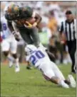  ?? WADE PAYNE — THE ASSOCIATED PRESS ?? Tennessee QB Joshua Dobbs (11) is tackled in the air by Florida defensive back Marcus Maye (20) during the second half Saturday in Knoxville, Tenn. Tennessee won, 38-28.