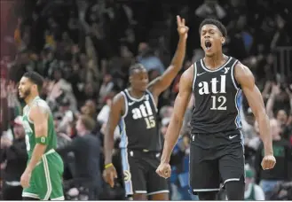  ?? AP photo ?? The Hawks’ De’Andre Hunter reacts after hitting a 3-pointer late in the second half of Atlanta’s win over Boston on Monday.