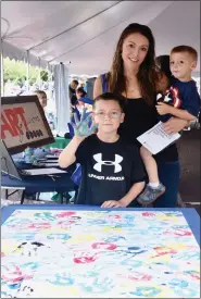  ?? JESI YOST PHOTOS - FOR MEDIANEWS GROUP ?? At left; Allen Matthews, 8, with his mom Valerie and Aiden, 2, prepares to add his handprint to the ArtFusion 19464 “hands on” display.