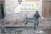  ?? [AP PHOTO] ?? An Afghan police walks outside a voter registrati­on center which was attacked by a suicide bomber Sunday in Kabul, Afghanista­n. Gen. Daud Amin, the Kabul police chief, said the suicide bomber targeted civilians who had gathered to receive national...