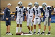  ?? The Associated Press ?? MOORE COACHING: Dallas Cowboys quarterbac­k coach Kellen Moore, left, talks to quarterbac­ks Dak Prescott (4), Dalton Sturm (1), Mike White (3) and Cooper Rush on July 28 during the team’s training camp in Oxnard, Calif.