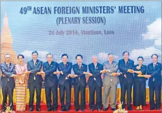  ?? AFP ?? Officials, including Foreign Minister Prak Sokhonn (third right), pose for a group photo during the opening ceremony of the 49th annual ASEAN ministeria­l meeting in Vientiane yesterday.