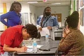  ?? ?? YouthWorks students sign up for placement considerat­ion with a Montgomery County workforce specialist during a Meet the Employers mixer at The Job Center on March 14.