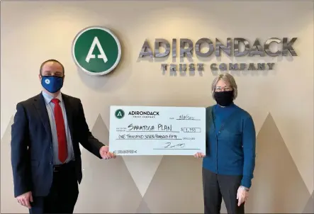  ?? PHOTO PROVIDED ?? Adirondack Trust president and CEO Charles V. Wait, Jr. presents a check to executive director Maria Trabka of Saratoga PLAN.