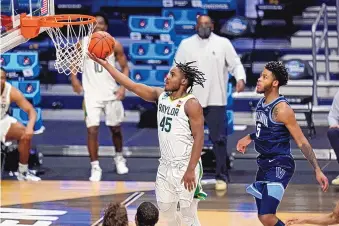  ?? AJ MAST/ASSOCIATED PRESS ?? Baylor guard Davion Mitchell (45) drives past Villanova guard Justin Moore (5) for a basket on Saturday. The Bears relied on defense and more 2-point buckets than usual to defeat the Wildcats.