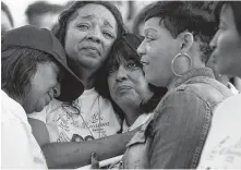  ?? Melissa Phillip / Houston Chronicle ?? Stacey Robinson, second from left, attends a memorial in March 2016 for her daughters, Brianna and Jade.