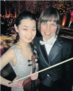  ??  ?? VSO school of music string orchestra — led by Carla Birston, right, and featuring violinist Lucy Wang, 17, left — got the party started.