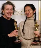  ??  ?? Nomadland star Frances Mcdormand, left, and director Chloe Zhao hold their Oscars