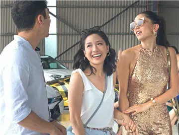  ?? — Warner Bros photo ?? Constance Wu (centre) in ‘Crazy Rich Asians’ which has earned more than RM924 million at the box office.