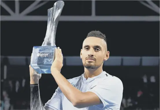  ??  ?? 2 Nick Kyrgios holds aloft the Brisbane Internatio­nal trophy after the Australian had beaten Ryan Harrison in the final yesterday.