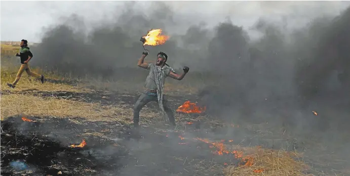  ??  ?? A Palestinia­n protester during clashes with Israeli troops at the Israel–Gaza border this week.