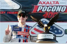  ??  ?? Ryan Blaney with the trophy in Victory Lane after winning the Monster Energy NASCAR Cup Series Axalta presents the Pocono 400 at Pocono Raceway in Long Pond, Pennsylvan­ia, on Sunday. (AFP)