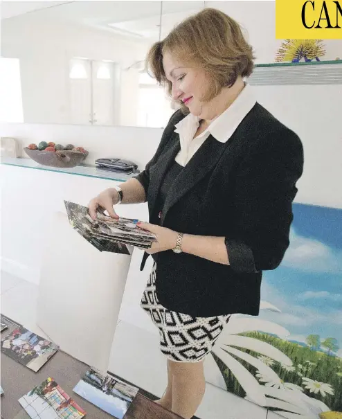  ?? WILFREDO LEE / THE CANADIAN PRESS / AP ?? Canadian diplomat Roxanne Dube looks through old photos of her children during an interview in Miami in February. Her younger son is back in Canada after making a plea deal in a double-murder case.