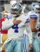  ?? SMILEY N. POOL/DALLAS MORNING NEWS ?? Cowboys quarterbac­k Dak Prescott (4) celebrates after throwing a touchdown pass against the 49ers on Jan. 16, 2022, in Arlington, Texas.