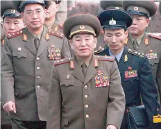 ?? — AFP ?? This December 13, 2007 file picture shows Kim Yong Chol and North Korean soldiers crossing the border which divides the two Koreas to attend the interKorea­n general talks at the South’s side of the truce village of Panmunjom.