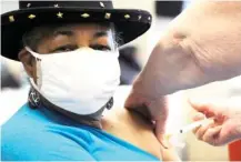  ?? AP PHOTO/JAY REEVES ?? Georgette Moon receives a COVID-19 vaccine at the county health department in Tuskegee, Ala., on Jan. 25. Moon, a former city council member, said she wanted to both protect herself and be a role model to encourage others to get the shot.