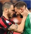  ?? THE ASSOCIATED PRESS ?? AC Milan’s Leonardo Bonucci, left, consoles goalkeeper Gianluigi Donnarumma on Sunday.