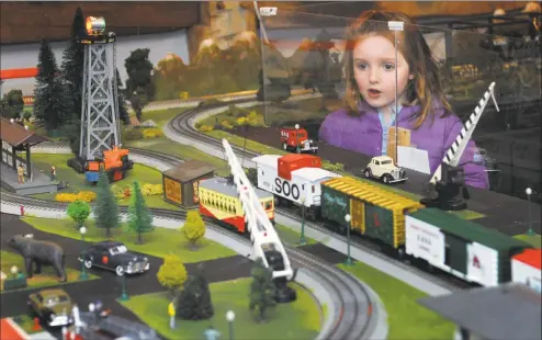  ?? Erik Trautmann / Hearst Connecticu­t Media ?? Zoe Turner, 5, of Shelton, looks at The Wilton Historical Society Great Trains Holiday Show on Nov. 24 at the Society on Danbury Road in Wilton. The train show continues through Jan. 21.
