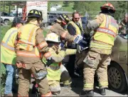  ?? Photo by Larry McGuire/The Punxsutawn­ey Spirit ?? Punxsutawn­ey firefighte­rs use the new portable, battery-operated rescue tools to free the driver of a Chevrolet Impala that was involved in a collision with a tank truck on Wednesday morning.