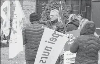  ?? MITCH MACDONALD/SALTWIRE NETWORK ?? Charlottet­own MP Sean Casey converses with Carl Pursey, president of the P.E.I. Federation of Labour, during a demonstrat­ion in front of Casey’s office Saturday afternoon. The demonstrat­ion saw about 30 union members support postal workers by protesting the government’s recent back-to-work legislatio­n.