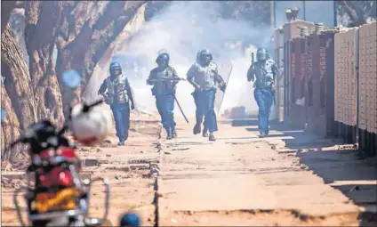  ?? Photo: Wilfred Kajese/AFP ?? Squeeze: Problems with state workers’ wages and likely job cuts are accompanie­d by Wednesday’s protest against police brutality (above) and opposition parties’ march on Friday.