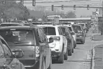  ?? ?? A long line of vehicles waits at a traffic light on Ford Road in Canton on Tuesday. The desire to make roadway changes in an area that can see more than 40,000 vehicles at peak times, according to MDOT, has been a long-standing one.