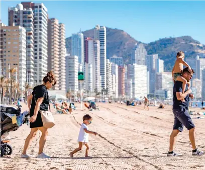  ?? ?? Winter sun: Holidaymak­ers banish the January blues on Benidorm Beach in Spain this week