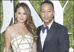  ?? AP ?? Singer John Legend is shown with his wife Chrissy Teigen at a charity event last month.