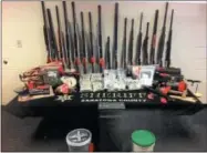  ?? PAUL POST PHOTO ?? Police recovered 18 long guns, two pistols and large quantities of cocaine and marijuana.