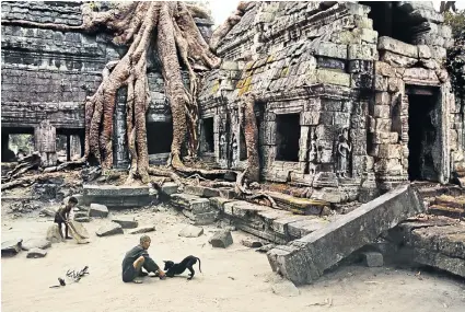  ??  ?? The temple caretaker and his dog, Ta Prohm, Angkor, Cambodia, 1999.
