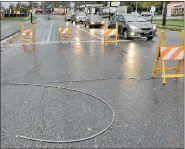  ?? MEDIANEWS GROUP FILE PHOTO ?? Vehicles drive past barricades at High Street and Armand Hammer Boulevard where a wire was laying on the road during high winds from Hurricane Sandy.